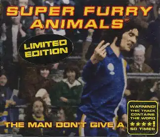 A dark-haired man in blue, white and yellow football kit scowls as he turns to his left, holding the index and middle fingers up on his right hand, his palm facing inwards. The hand points to an out-of-image figure, but appears to be pointing to the viewer. "Super Furry Animals" is rendered in yellow and red text across the top, while along the bottom the single's title is partially given: "The Man Don't Give a ****". The final word is obscured by a sticker, which itself claims that the word is used 50 times during the song