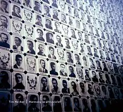 A memorial with pictures of people assorted in a grid