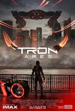 Ares stands next to a red light cycle while looking at a city that is under attack. A giant red Recognizer appears above the city along with several aircraft. The film's title is overlaid on the city. Credits for the film appear at the bottom.