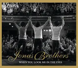 The brothers on stage, facing the audience, greeting them